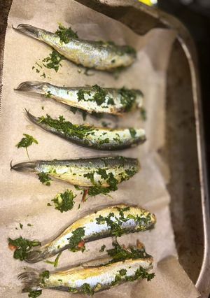 A picture of Oven grilled sardines with parsley and garlic.