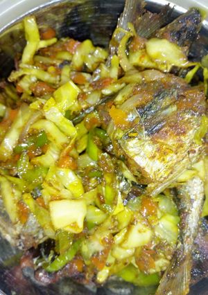 A picture of Fried fish with veggies.