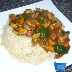 A picture of Couscous with chicken, sausage & veggie sauce.