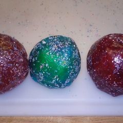 A picture of Jolly rancher covered apples with edible glitter.