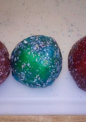 A picture of Jolly rancher covered apples with edible glitter.