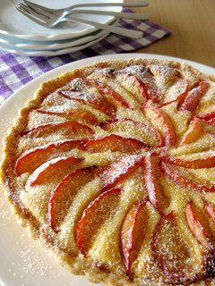 A picture of Almond Cheese Tart with Plums.