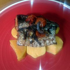 A picture of Oven baked salmon with sweet potatoes.