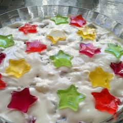 A picture of White jello cake with colorful filling.
