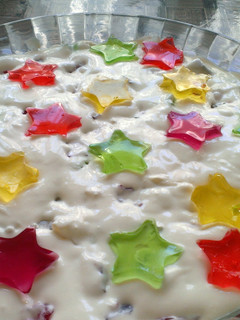 A picture of White jello cake with colorful filling.
