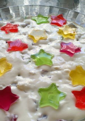 A picture of White jello cake with colorful filling.