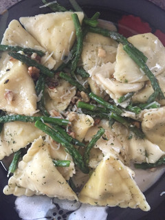 A picture of Ravioli With Sautéed Asparagus And Walnuts.