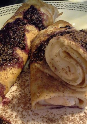 A picture of Ricotta Crepes with Raspberry-Chile Coulis and Chocolate Shavings.