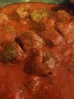 A picture of Italian Meat Balls in sauce.