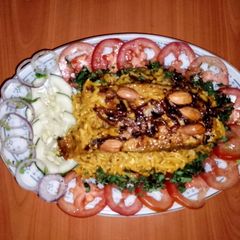 A picture of Fish kabsa 🐠🍅🌿.