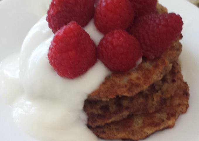 Vegan apple wheat pancake topped with yogurt and berries