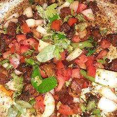 A picture of Mutton fry kadak with raw veggies.