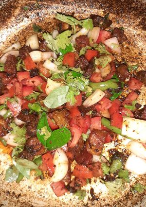 A picture of Mutton fry kadak with raw veggies.