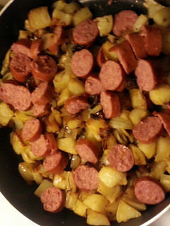 A picture of Kielbasa, potatoes and onions.