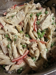 A picture of Chicken Penne Alfredo with veggies and homemade sauce.