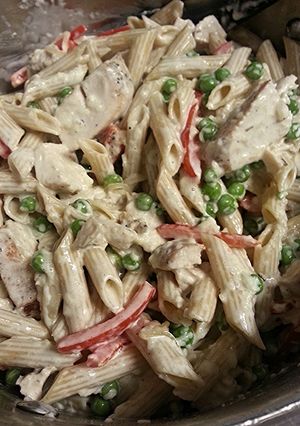 A picture of Chicken Penne Alfredo with veggies and homemade sauce.