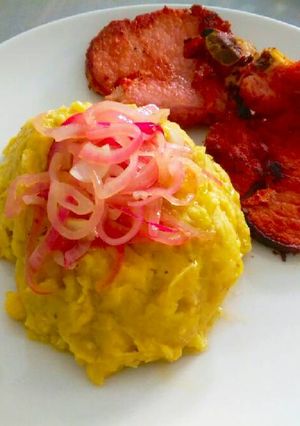 Una foto de Mangu o puré de plátanos con cebollas