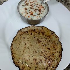 Methi Garlicky Bajara Roti With Cucumber Raita Fom My Kitchen A picture of Methi Garlicky Bajara Roti With Cucumber Raita Fom My Kitchen.