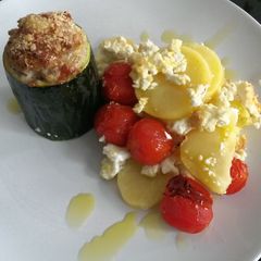 A picture of Zucchini filled with minced meat.