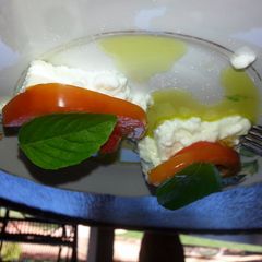 A picture of Ricotta, tomato, fresh basil and extra virgem olive oil.