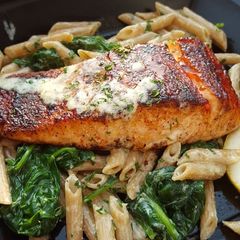 A picture of Bbq jerk salmon over pasta.