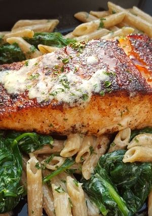 A picture of Bbq jerk salmon over pasta.