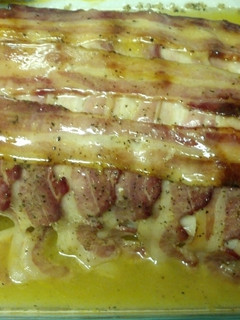 A picture of Bacon wrapped lemon pepper pork loin.
