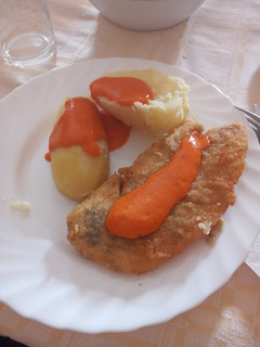 Una foto de Gallo adobado y empanado con papas cocidas y mojo de pimiento