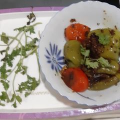 A picture of Stuffed capsicums and tomatoes.