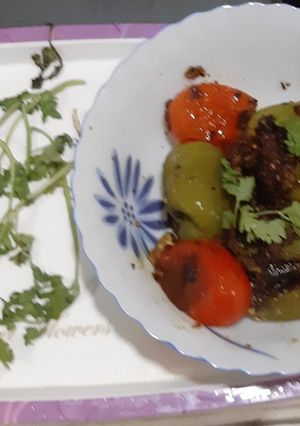A picture of Stuffed capsicums and tomatoes.