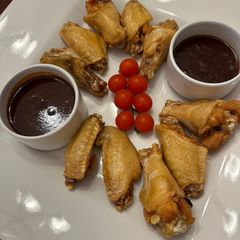 A picture of Chicken Wings with Mamba Sauce and Honey Ginger Sriracha Sauce.