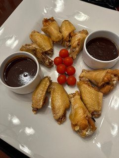 A picture of Chicken Wings with Mamba Sauce and Honey Ginger Sriracha Sauce.