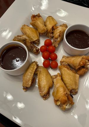 A picture of Chicken Wings with Mamba Sauce and Honey Ginger Sriracha Sauce.
