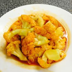 A picture of stir-fry cauliflower with ketchup and soy sause - Chinese dish.