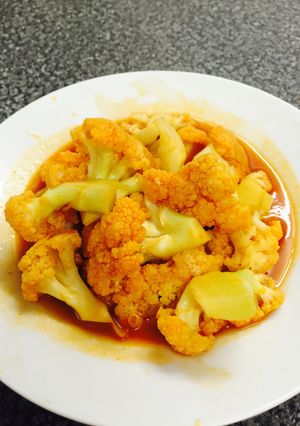A picture of stir-fry cauliflower with ketchup and soy sause - Chinese dish.