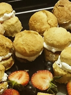A picture of Mini scones with Jam and clotted cream.