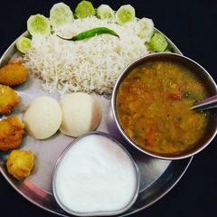 South Indian Platter Sambhar Rice Idli Vada A picture of South Indian Platter Sambhar Rice Idli Vada.