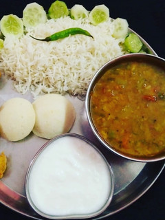 A picture of South Indian Platter Sambhar Rice Idli Vada.