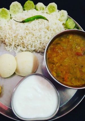 A picture of South Indian Platter Sambhar Rice Idli Vada.