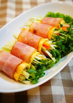 A picture of Raw Vegetables Wrapped with Bacon and Eggs.