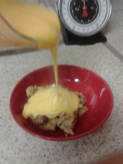 A picture of Rum and Raison Bread pudding, with Custard.