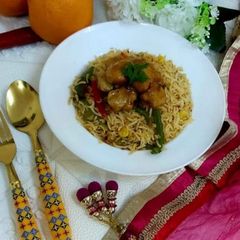 A picture of Orange Chicken with fried rice.
