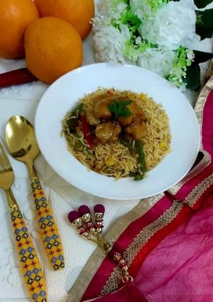 A picture of Orange Chicken with fried rice.