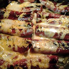 A picture of Green beans with hotdogs.