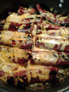 A picture of Green beans with hotdogs.