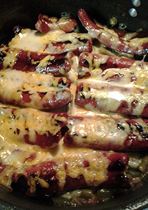 A picture of Green beans with hotdogs.