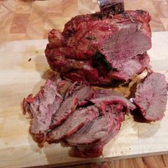 A picture of Lamb leg on foil.