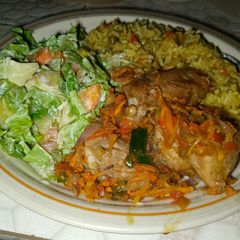 A picture of Fried rice, pepper chicken and potato salad.