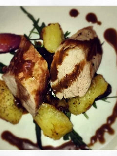 A picture of Pork fillet with crushed potatoes and balsamic dressing.
