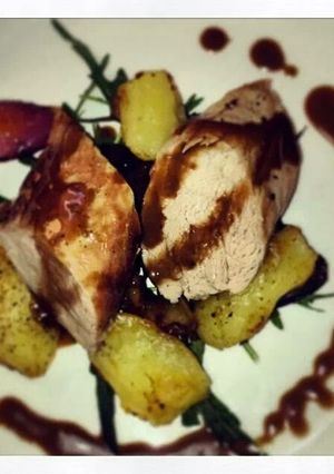 A picture of Pork fillet with crushed potatoes and balsamic dressing.